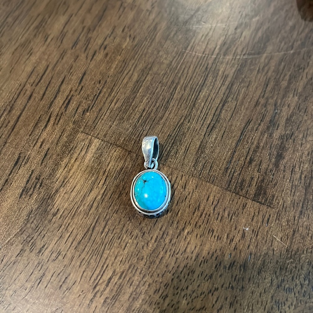 Small turquoise gemstone set in 925 sterling silver.